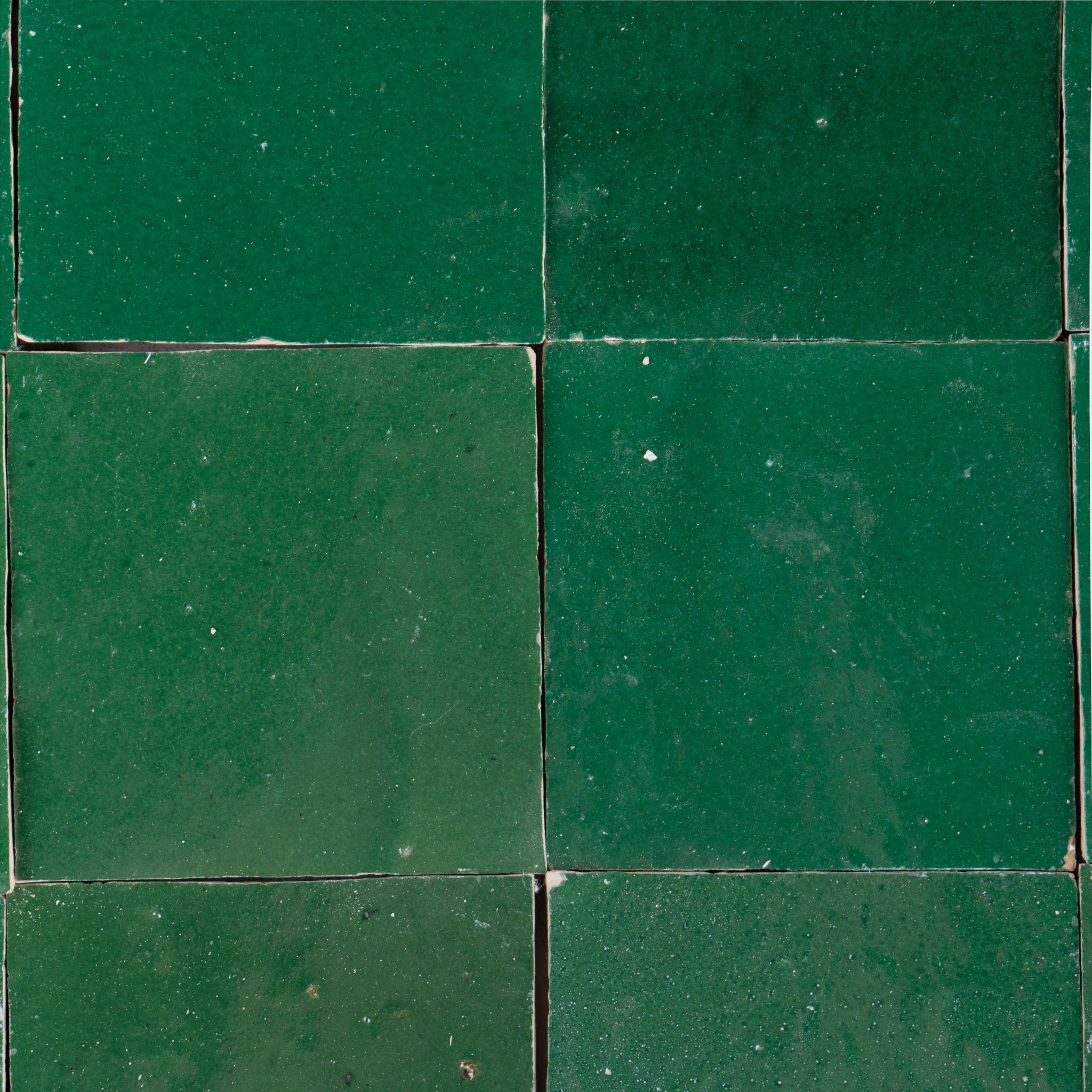 Emerald green zellige tile backsplash showing glossy handmade Moroccan terracotta