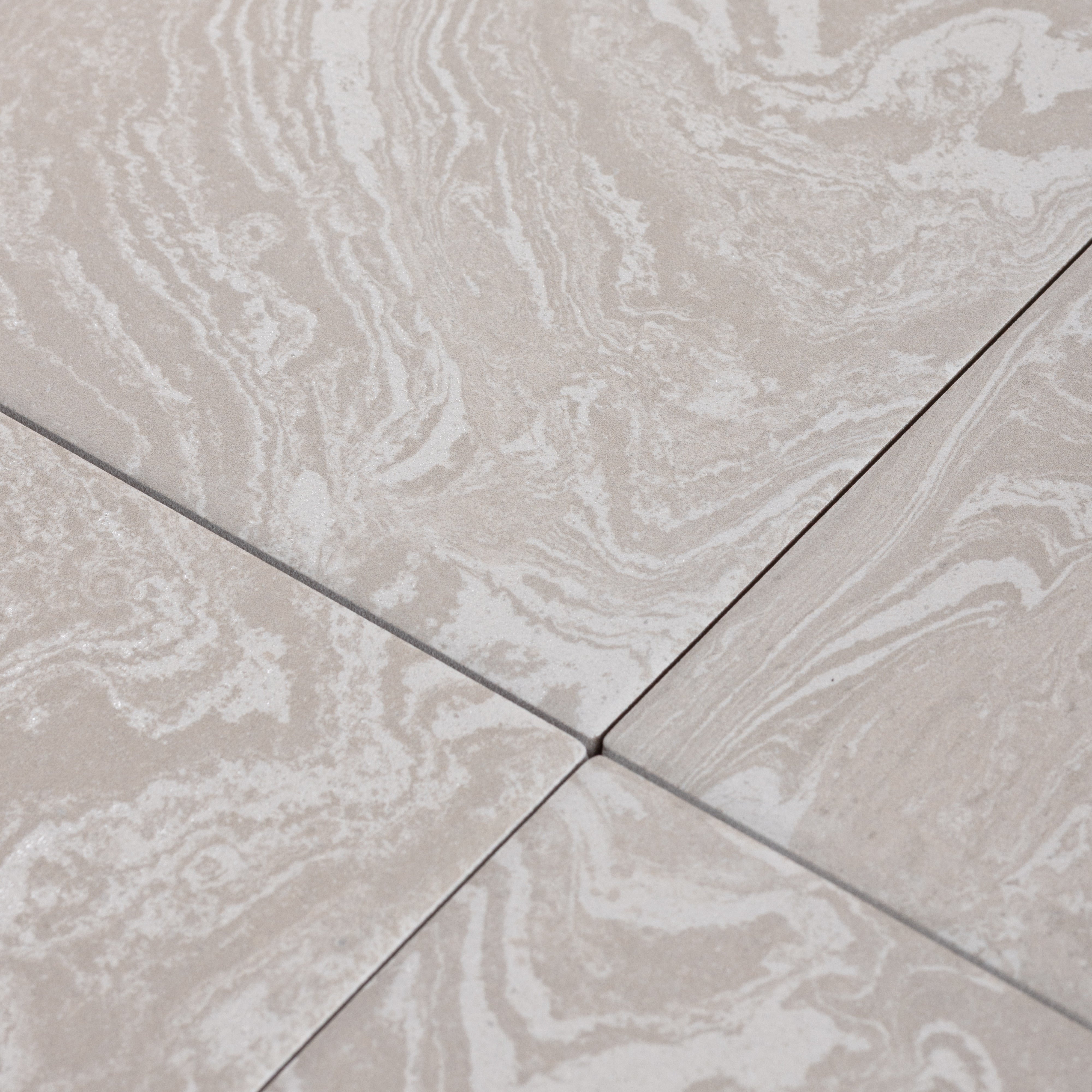 Close-up of beige tiles with marble-like pattern porcelain tile