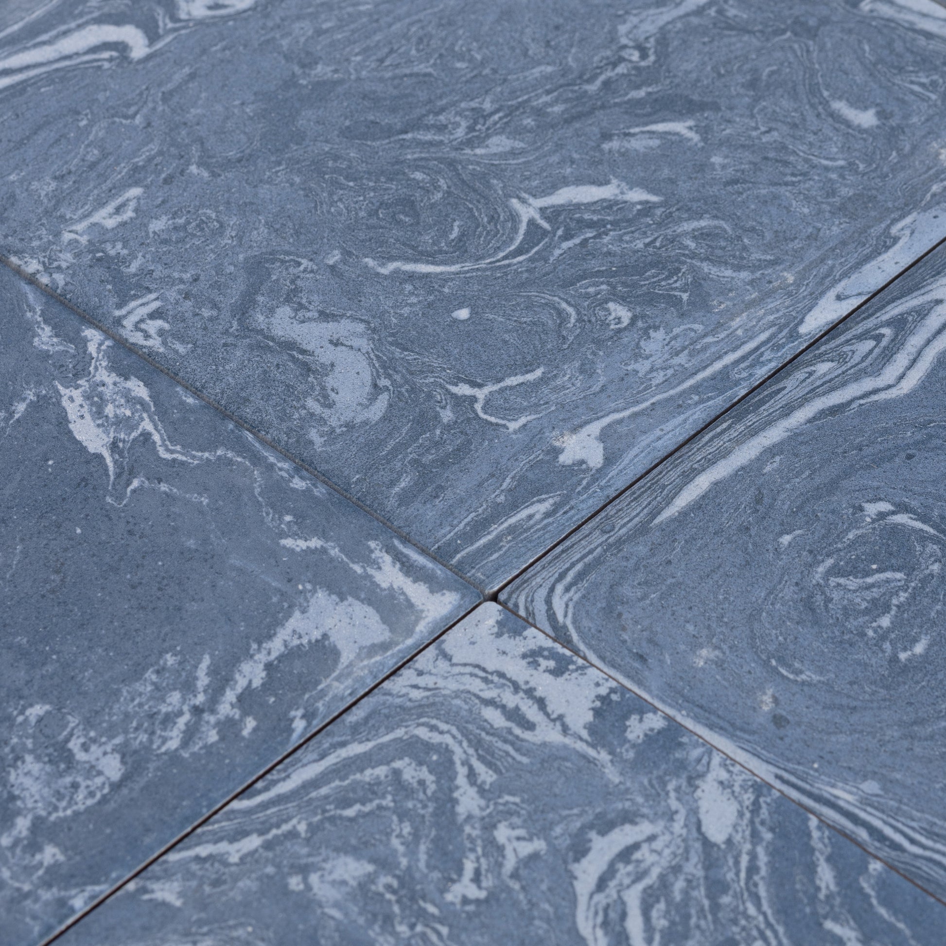 Close-up of blue marbled tiles with a focus on texture and pattern.