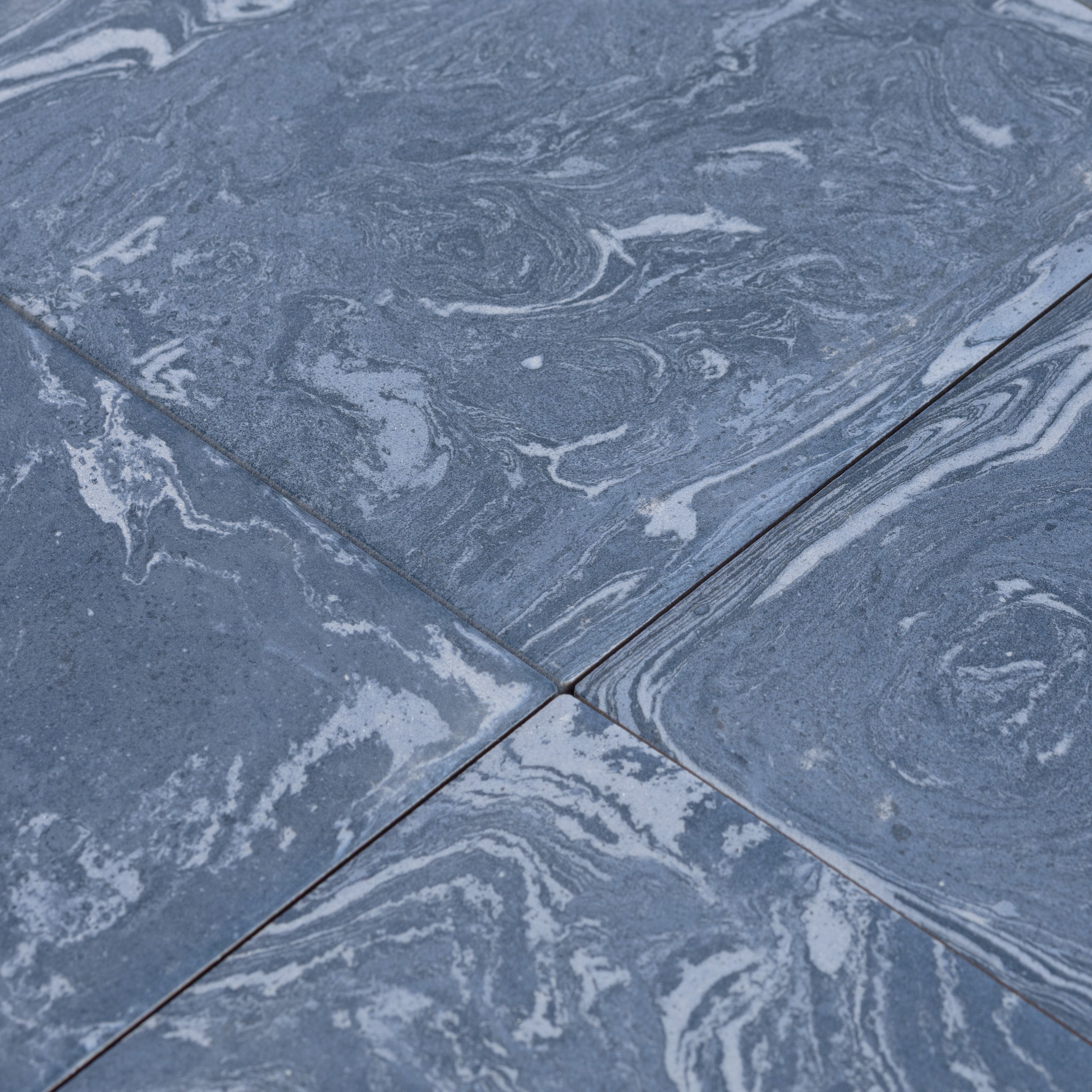Close-up of blue marbled tiles with a focus on texture and pattern.
