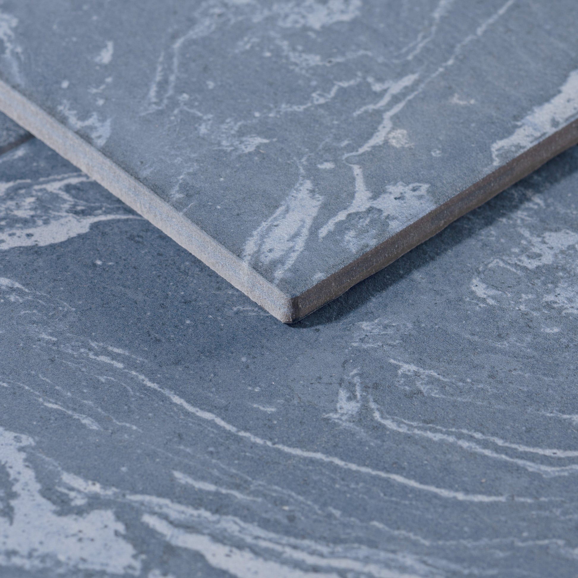 Close-up of a blue stone tile with a marbled pattern