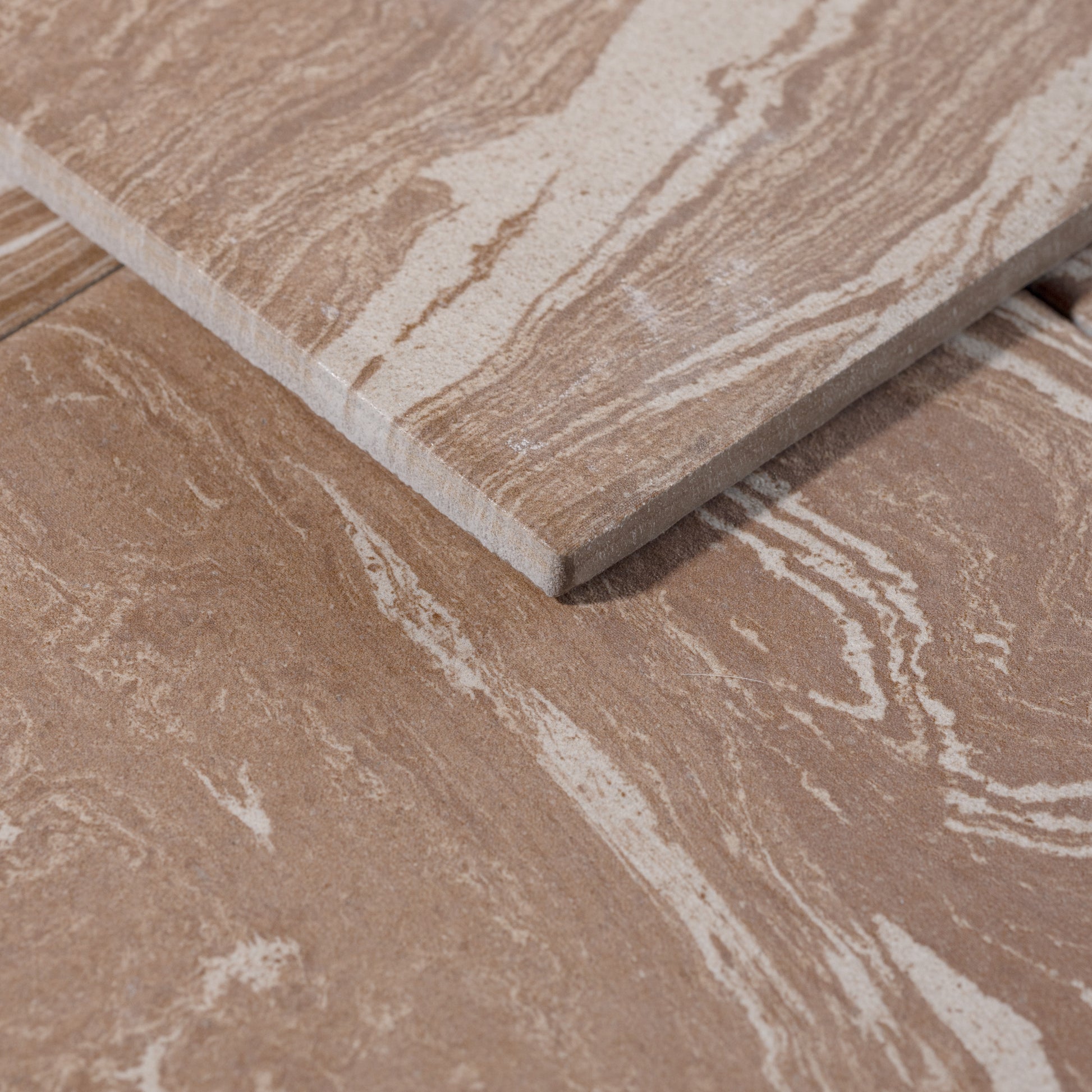 Close-up of a brown ceramic tile with a marbled pattern porcelain tile 8x8 tile