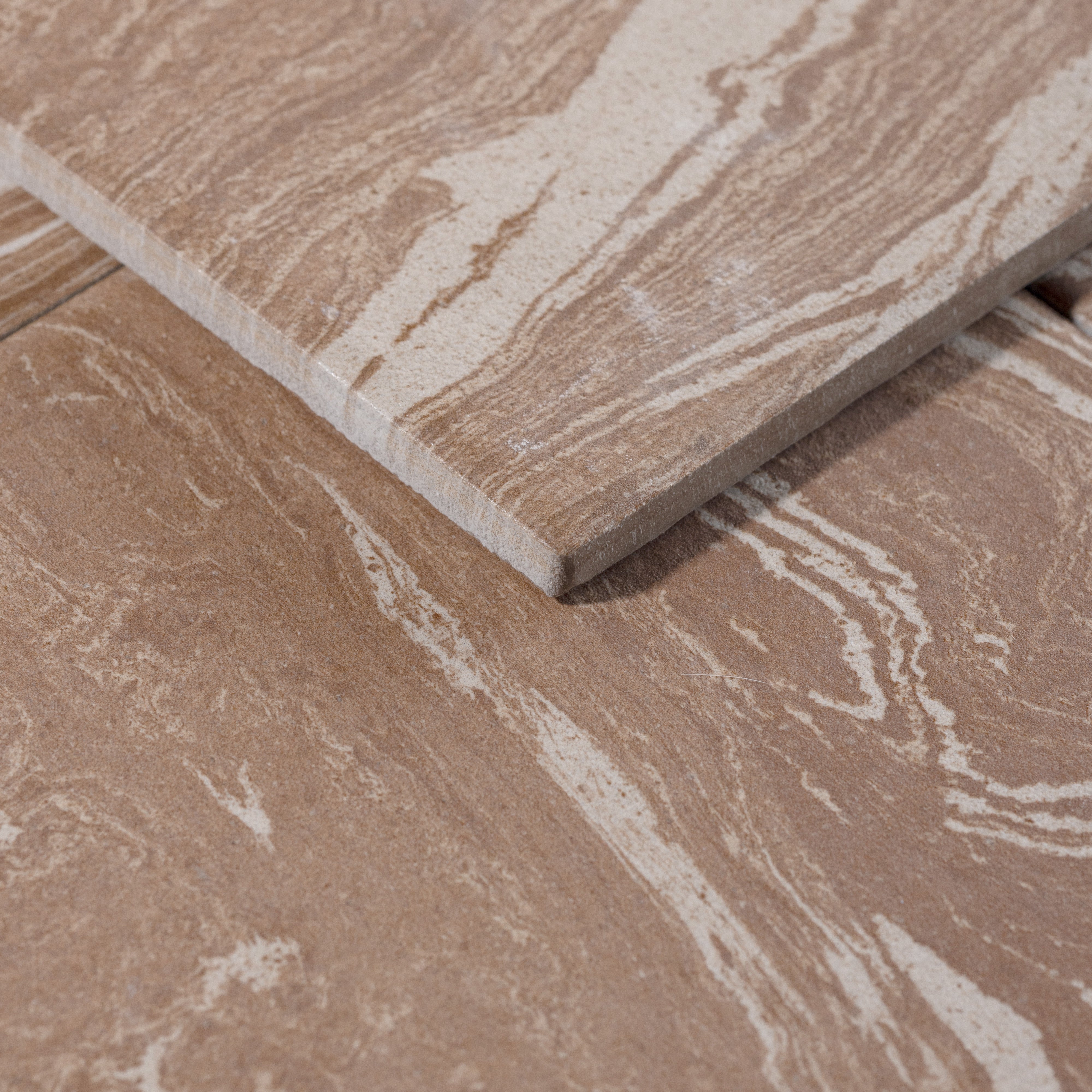 Close-up of a brown ceramic tile with a marbled pattern porcelain tile 8x8 tile