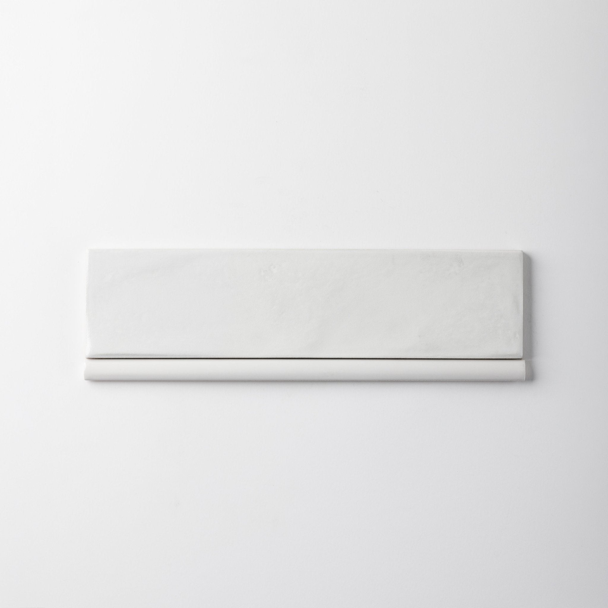 Extruded Off White Glossy Pencil - 1⁄2X12 - Cemento Collection