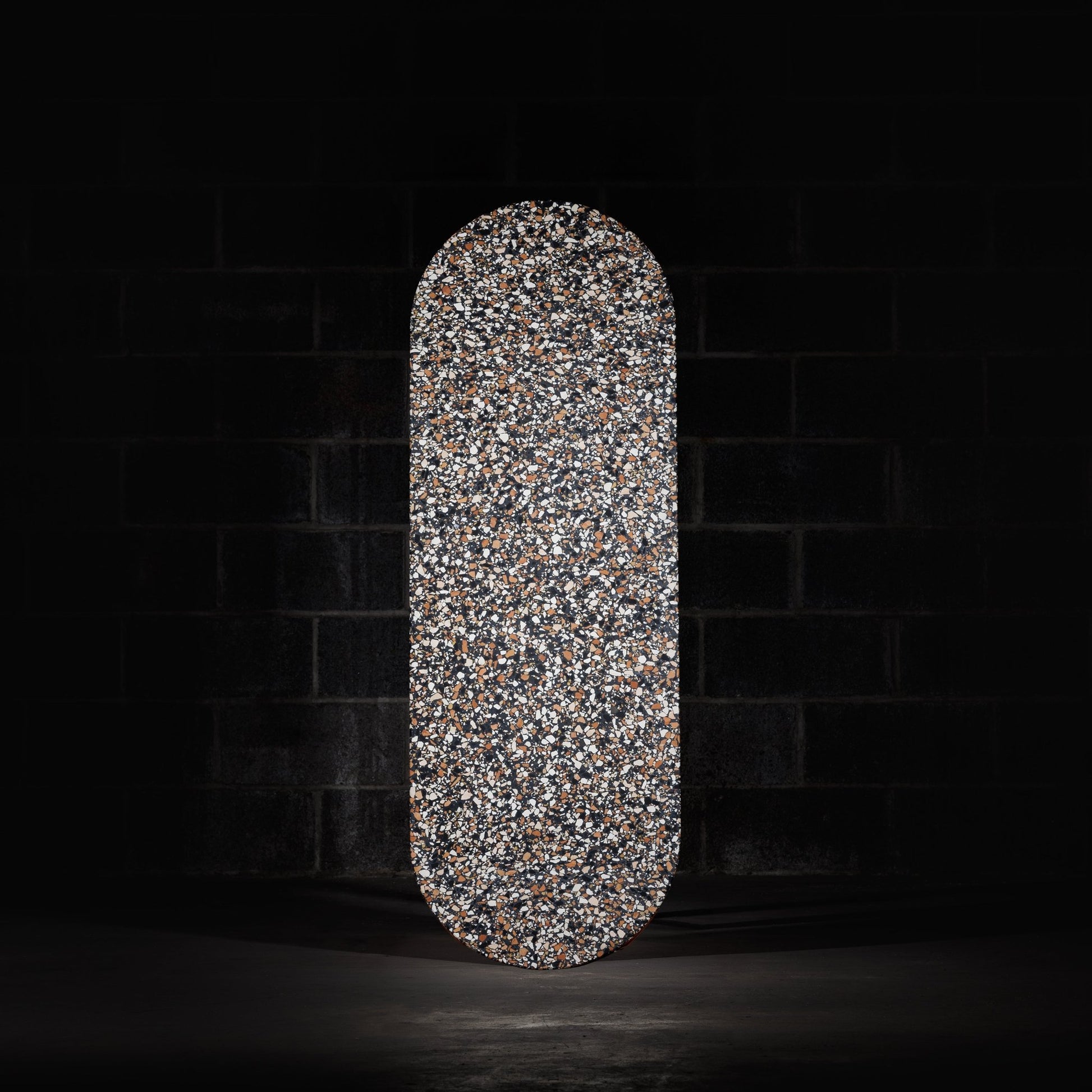 Pill shaped table top terrazzo tile. ponza black tile