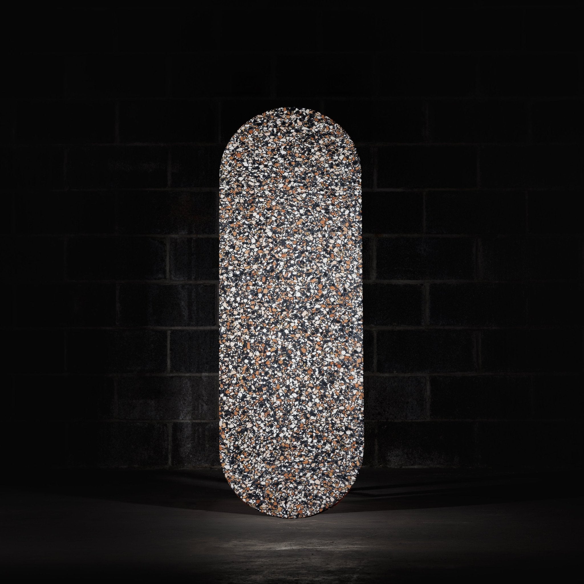 Pill shaped table top terrazzo tile. ponza black tile